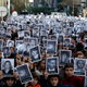 Members of Argentina’s Jewish community hold photos of the victims of the 1994 bombing.